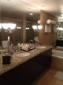 Double vanity and a peek at the soaking tub.